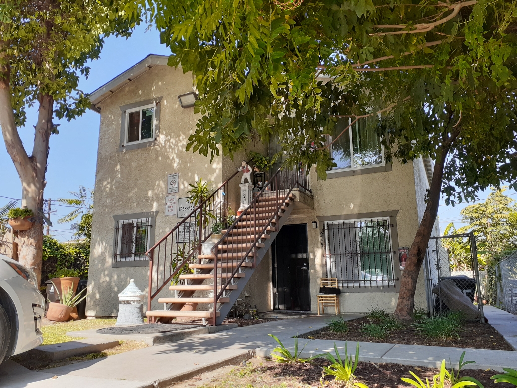 A house with a staircase leading to the front door.